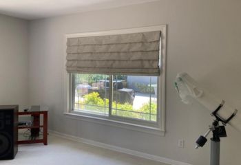 Custom Roman window shades installed on wide home office window in Fremont, partially open for natural light
