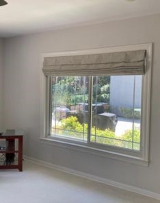 Custom Roman window shades installed on wide home office window in Fremont, partially open for natural light